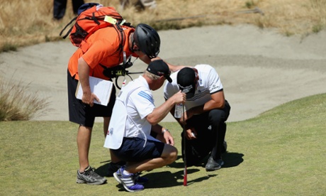 Jason Day of Australia is assisted after collapsing on the ninth hole during the second round of the US Open.