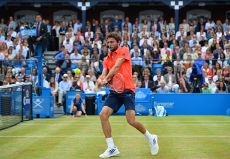 Gilles Simon volleys a return against Kevin Anderson.