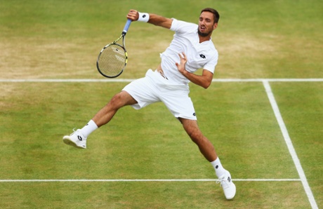 Viktor Troicki smashes a return to Andy Murray.