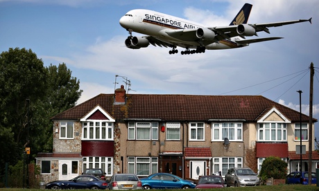 A passenger plane comes in low over housing as it lands at Heathrow airport.