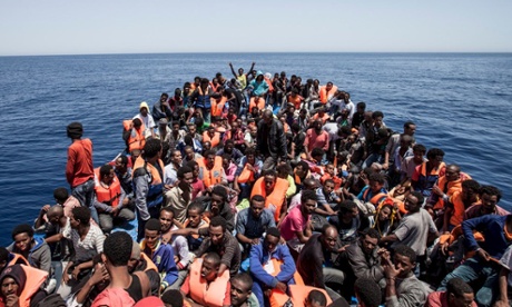 Migrants crowd the deck of their wooden boat off the coast of Libya: the HMS Bulwark is being withdrawn from search and rescue operations.