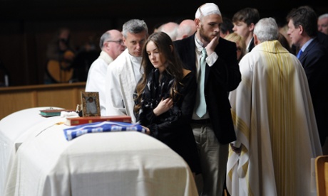 Amanda Donohoe looks at her sister’s casket during a service for Olivia Burke and Ashley Donohoe at St Joseph Catholic church in Cotati, California, on Saturday.