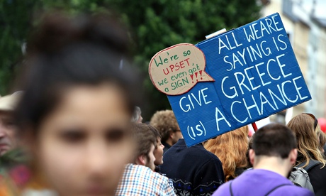 A protestor holds a sign reading 