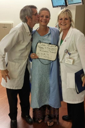 LaDonna Applebaum on her last day of radiation treatment, holding a sign that reads: ‘The ACA is working!’
