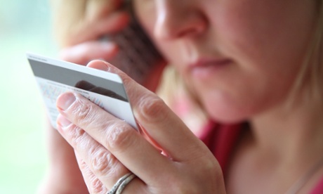 A woman on the phone with her bank card