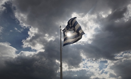 A Greek flag flutters Acropolis hill in Athens.