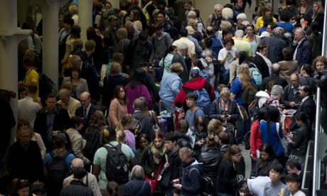Eurostar passengers wait stranded as Eurostar trains are canceled at St Pancras station in London.