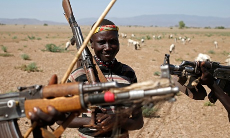 Turkana men carry rifles as they herd goats inside the Turkana region of the Ilemi Triangle, northwest Kenya December 21, 2014. The Ilemi Triangle is a disputed region in East Africa, claimed by South Sudan and Kenya, bordering also Ethiopia. The dispute arose from unclear wording of a 1914 treaty which tried to allow free movement of the Turkana people, nomadic herders who had traditionally grazed the area. Picture taken on December 21, 2014.