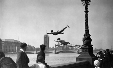Two divers launching off the Embankment into the River Thames, London.