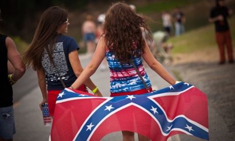 Two young women with a confederate flag.