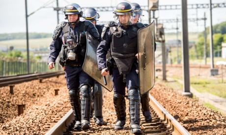 French riot police officers repsond to striking employees from a ferry company in Calais yesterday.