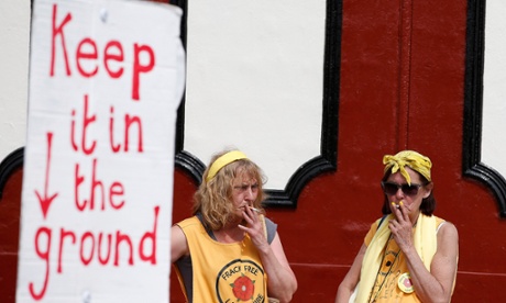 Anti-fracking protesters smoke during a demonstration outside County Hall in Preston, Britain June 24, 2015. Lancashire County Council is debating an application by shale gas firm Cuadrilla Resources to frack on the Fylde coast, local media reported.