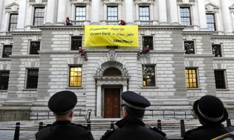 Greenpeace protesters remind George Osborne of his pledge to create a green investment bank in 2010.