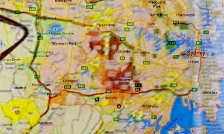 Maps photographed in Asio headquarters at a prime ministerial photo op, overlaid with suburb names.