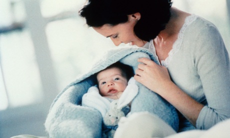 mother holding baby in arms