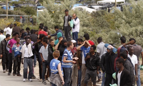 Migrants queue for food at a distribution point in the so-called Jungle 2 camp in Calais, France.