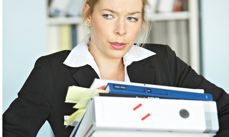 Young female intern carrying files
