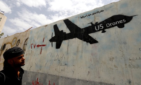 A man looks at graffiti showing a US drone, in Sana'a, Yemen.