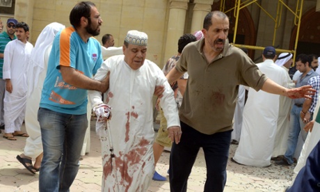 An injured man is helped following a blast at Imam Sadiq Mosque in al-Sawaber, Kuwait City.