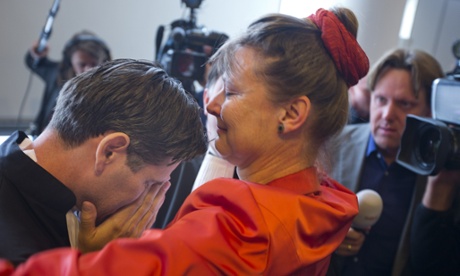 Urgenda Foundation director Marjan Minnesma hugs lawyer Roger Cox, left, after a Dutch court ordered the government to cut the country's greenhouse gas emissions by at least 25% by 2020.