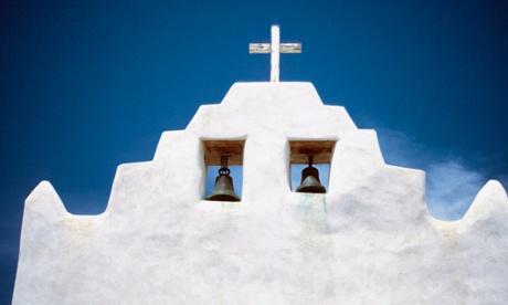 Bells and a cross on top of Mission San Jose de Laguna Church, New Mexico.
