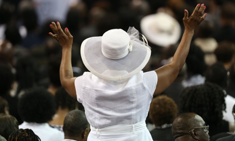 CHARLESTON, SC - JUNE 26:  Mourners attend the funeral at the College Charleston TD Arena where President Barack Obama is scheduled to deliver the eulogy for South Carolina State Sen. Clementa Pinckney who was killed during the mass shooting at the Emanuel African Methodist Episcopal Church along with eight others on June 26, 2015 in Charleston, South Carolina. Suspected shooter Dylann Roof, 21 years old, is accused of killing nine people on June 17th during a prayer meeting in the church, which is one of the nation's oldest black churches in Charleston.  (Photo by Joe Raedle/Getty Images)CrimeLawJusticeHuman InterestPeoplePoliticsGovernmenttopicstopixbestoftoppicstoppix