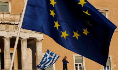 EU and Greek flags are waved in Athens.