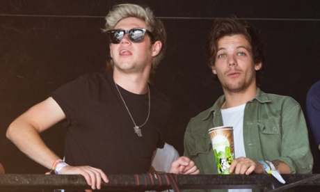 Genuine young people: Niall Horan, left, and Louis Tomlinson of One Direction watch James Bay at Glastonbury on Friday.