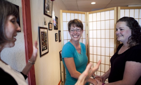 A small ceremony to marry Misty Collins, center, and Melisa Edison Friday in Rapid City, South Dakota.