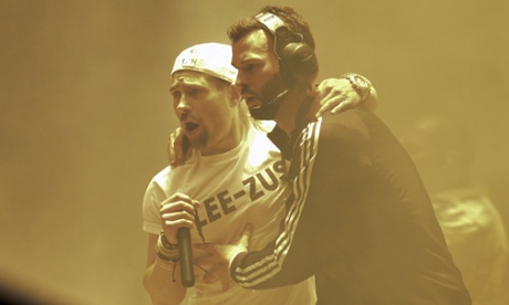 Lee Nelson is escorted off the stage.