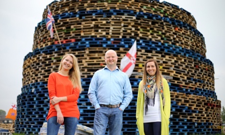 Olga Dominiak, Philip Dean and Monika Lubasinska stand next to a 12 July bonfire that has become a symbol of the project’s integration of migrant families. 