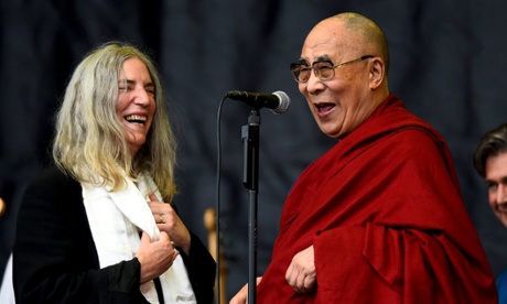Patti Smith (L) shares a light moment with the Dalai Lama as she performs on the Pyramid stage at Worthy Farm in Somerset during the Glastonbury
