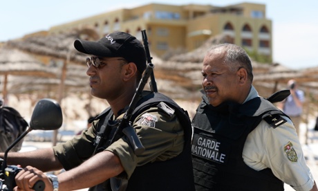 Members of the Tunisian National Guard ride across the beach in front of the Imperial Marhaba hotel in Sousse.