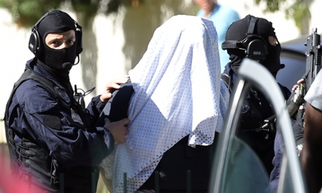 French police escort Yassin Salhi as they leave his flat in a Lyon suburb on 28 June.