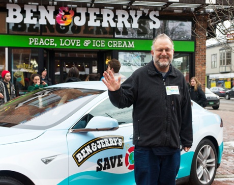 ​Ben & Jerry's co-founder Jerry Greenfield kicks off the national Save Our Swirled tour at the Ben & Jerry's Scoop Shop in Burlington, Vermont this spring. Behind him, the 100% electric Tesla vehicle which will deliver free ice cream and promote climate change awareness.