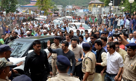 Indian actor Salman Khan waves to the crowds as he arrives at his sister’s wedding reception on 25 May.