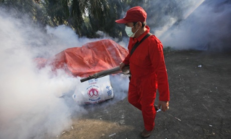 A government official sprays anti-mosquito fog in a preventive attempt to control dengue fever