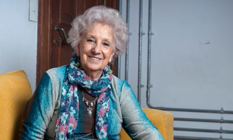 Estela Carlotto sitting on a sofa, smiling