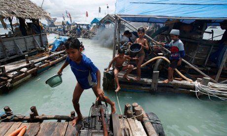 A child walks at a floating mine site off Bangka Island, Indonesia.