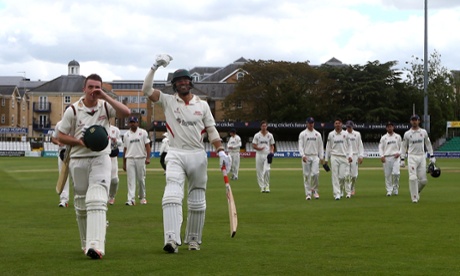 Lewis Hil, left, and Andrea Agathangelou of Leicestershire celebrate their team's title victory as they leave the pitch.