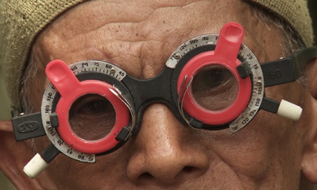 Adi Rukun tests the eyes of one of the men who killed his brother.