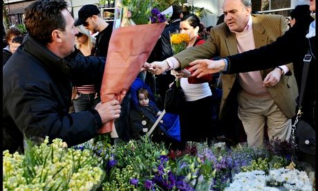 Stall holder and customers at a flower market