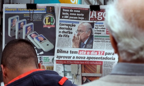People in São Paulo, Brazil, read the local newspaper front pages showing pictures of Sepp Blatter.