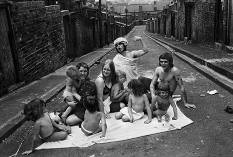 Two families sunbathing in Carville Road/Mason Street back lane, Byker, 1975.