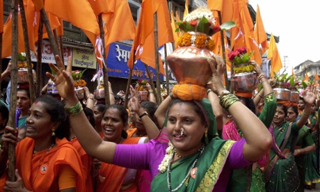 Nashik 2003: Hindu women devotees carry brass pots to make an offering in the River Godavari on the first day of the month-long Kumbh Mela
