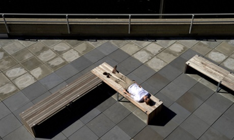 A women enjoys the afternoon sunshine on a terrace of the South Bank Centre in London on 29 June.