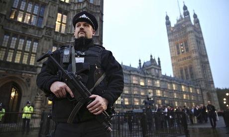 An armed police officer outside the Houses of Parliament, central London