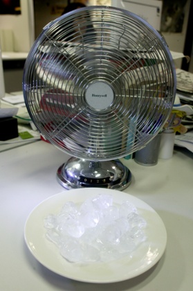 A  fan blowing air over ice cubes