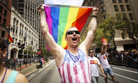 A man waves a rainbow flag while marching in the San Francisco gay pride parade, two days after the U.S. Supreme Court's landmark decision that legalized same-sex marriage throughout the country in San Francisco, California June 28, 2015.   REUTERS/Elijah Nouvelage:rel:d:bm:GF10000142963