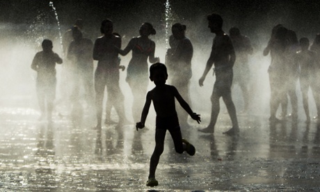 Children play as they cool down in a fountain beside Manzanares river in Madrid, Spain, Monday, June 29, 2015. Weather stations across Spain are warning people to take extra precautions as a heat wave engulfs much of the country